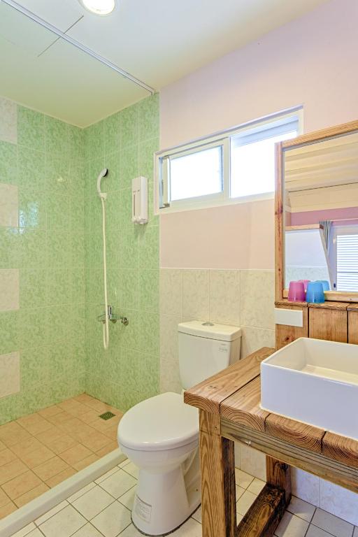 a bathroom with a toilet and a sink at Love Summer Hostel in Hengchun South Gate