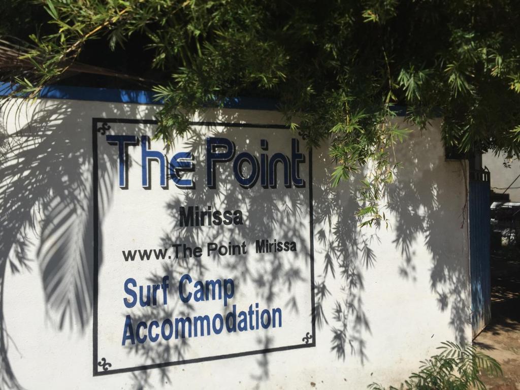 a sign that reads the point fitness surf camp accommodation at The Point Mirissa in Mirissa