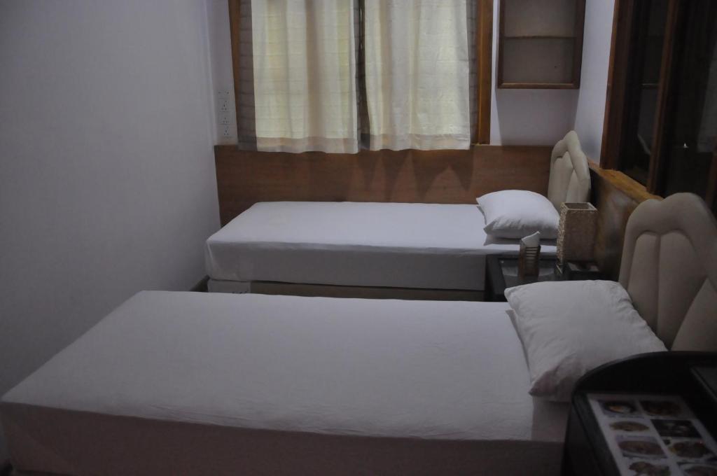 Postel nebo postele na pokoji v ubytování Rasdhoo Coralville