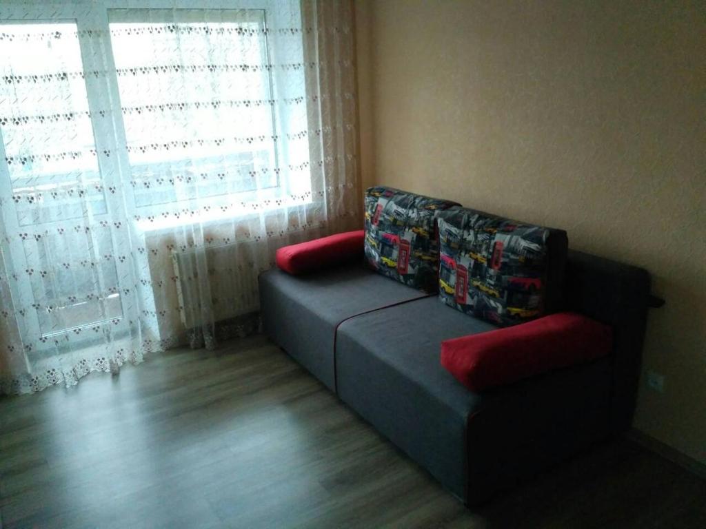 a living room with a couch and a window at Apartment on the World in Cherkasy