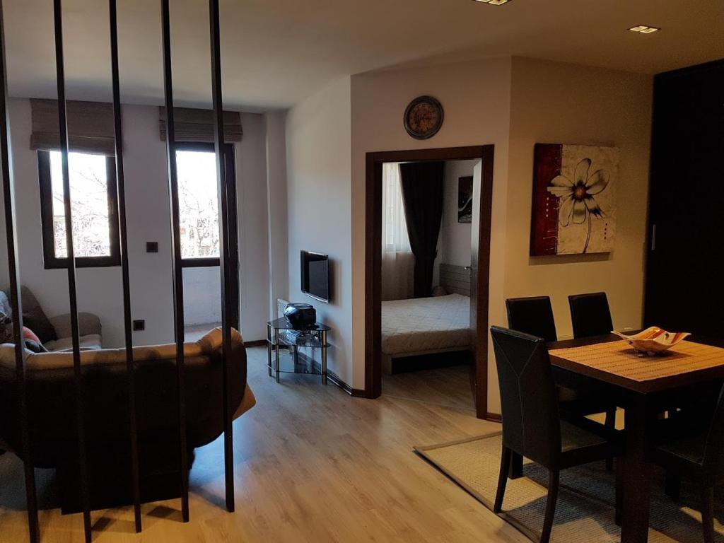 a living room with a table and a dining room at Lux Studio 45 in Fortuna in Bansko