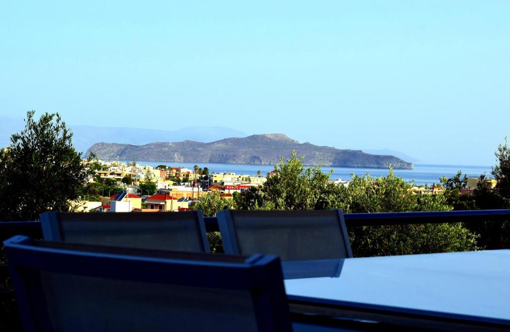 a balcony with two chairs and a view of the ocean at Μelpo's House in Kato Daratso