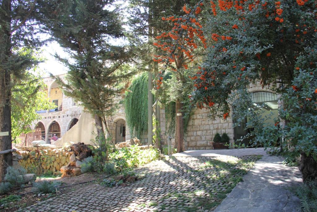 a garden with trees and flowers in a building at Domaine de Chouchene in Şaḩrat al Qashsh