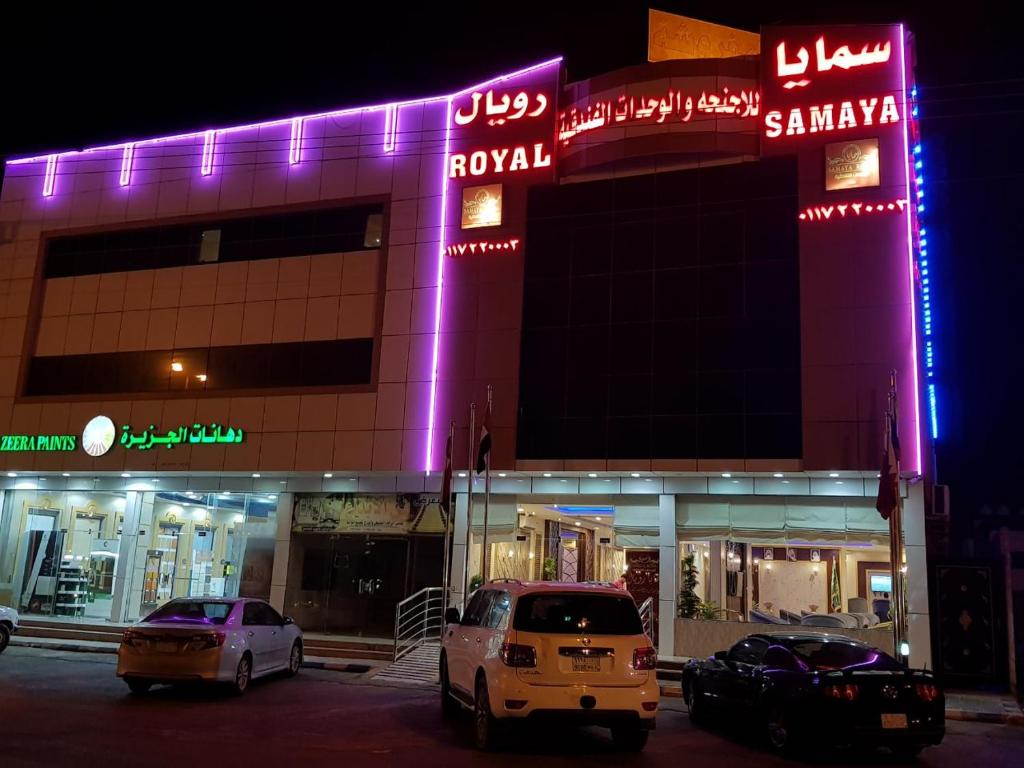 two cars parked in front of a building at night at Samaya Royal Afif in ‘Afīf