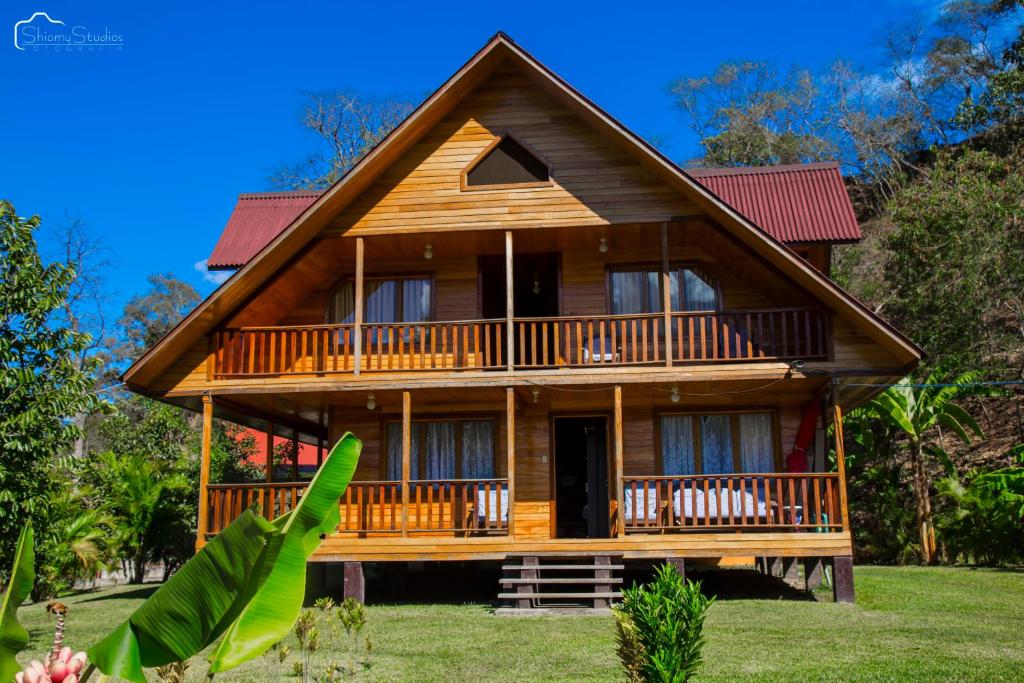 a large wooden house with a large deck at Ecolodge Don Felix in Quillabamba