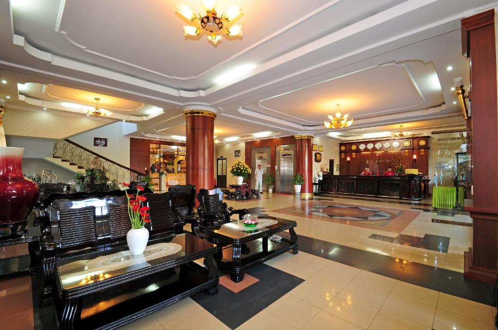 a lobby of a hotel with a table and chairs at Duy Tan Hotel in Hue