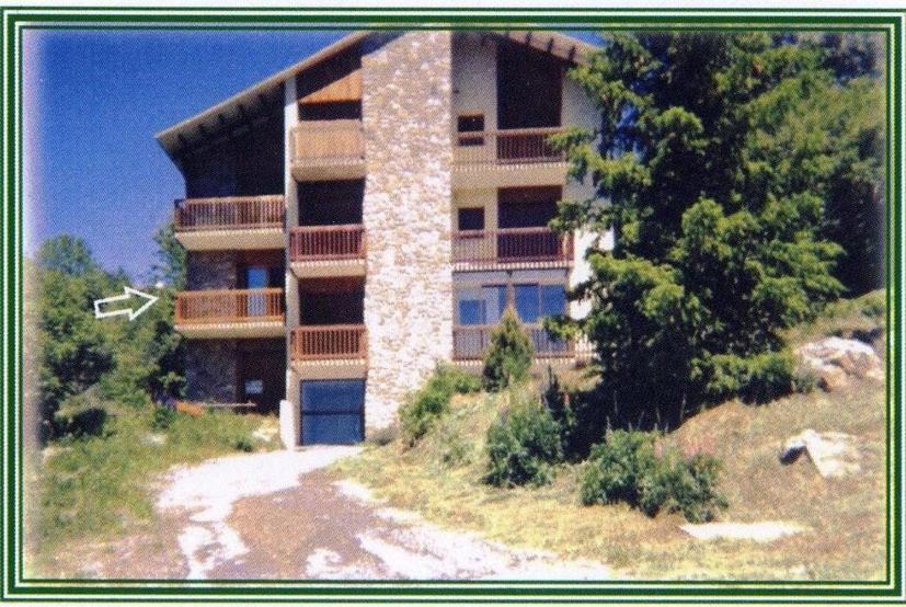 a large building on top of a hill with trees at Appartement La Marmotte in Font-Romeu