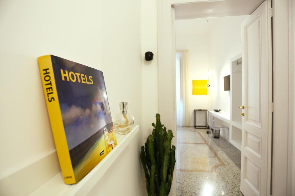 a book hanging on a wall in a room at Re Ruggero Rooms in Reggio Calabria