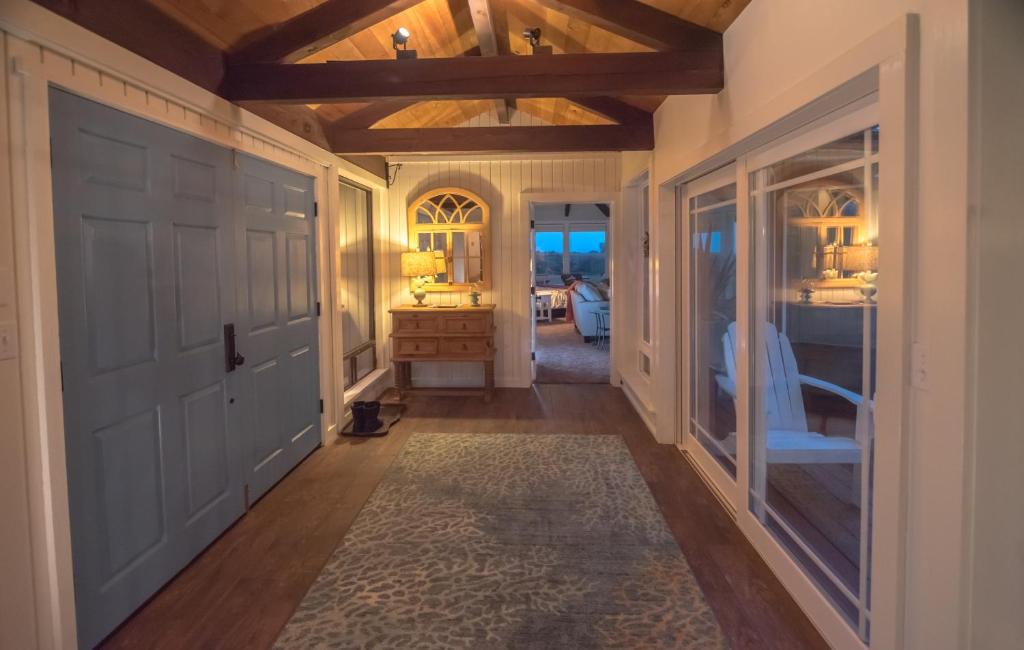 a hallway of a home with a door and a desk at Cliff House at Otter Point in Mendocino