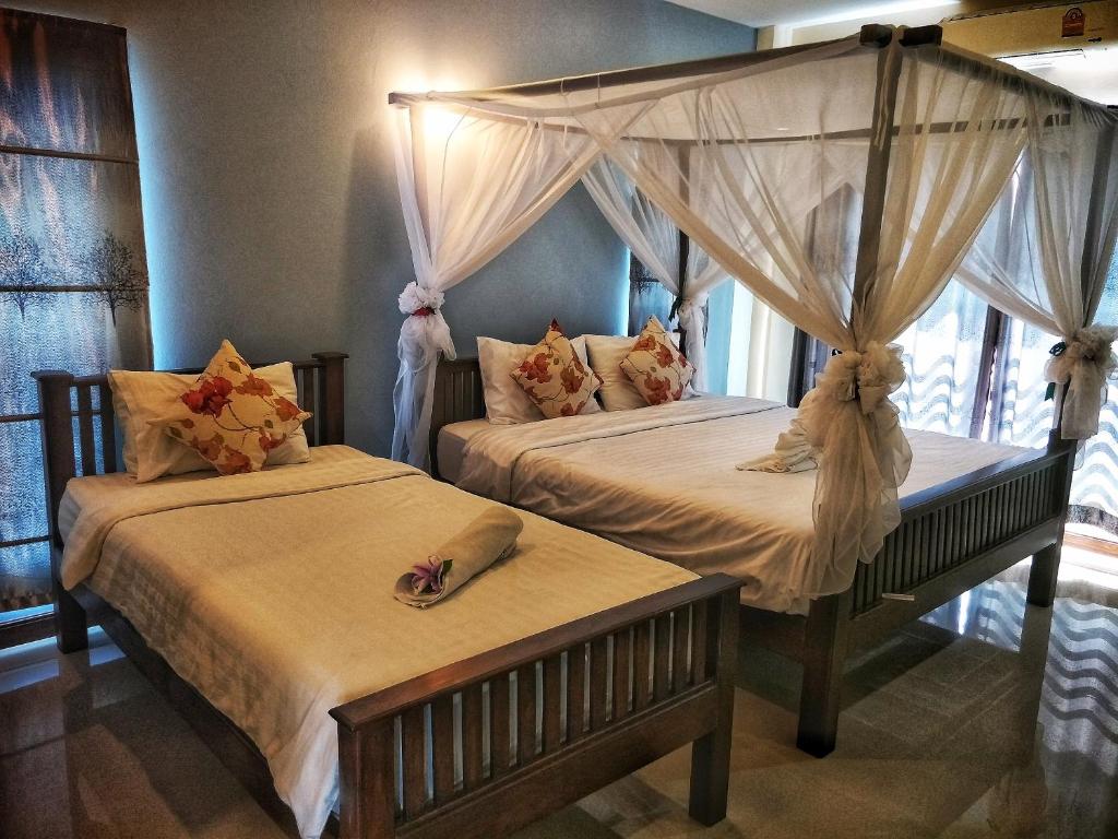 Postel nebo postele na pokoji v ubytování Blue House Sukhothai