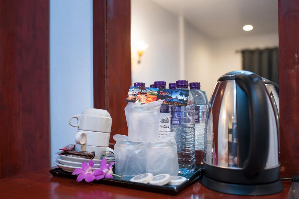 a counter with a coffee maker and a coffee pot at Beck's Resort in Haad Pleayleam