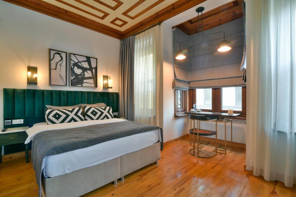 a bedroom with a bed and a desk in it at Istanbul Life Hotel in Istanbul