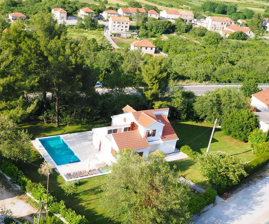 an aerial view of a house with a swimming pool at Holiday Home Magud in Gruda