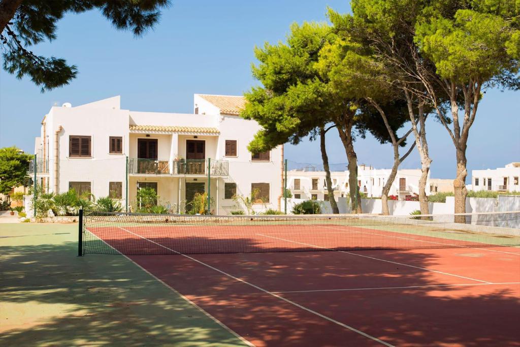 a tennis court in front of a house at Boa Vista San Vito - Area Fitness, Barbecue Area, Tennis Court in San Vito lo Capo