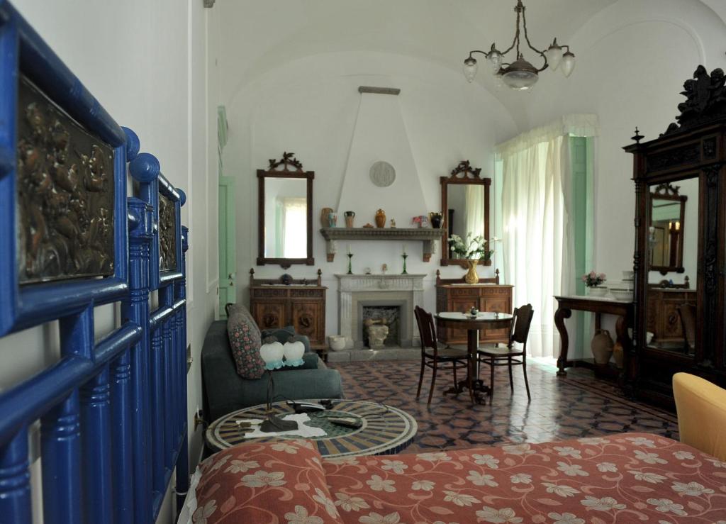 a living room with a bed and a fireplace at Casa Raffaele Conforti in Maiori