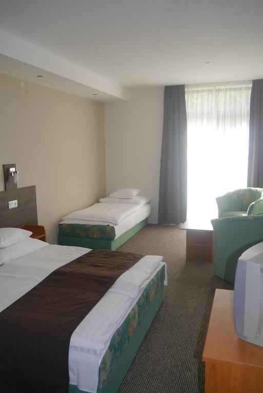 Postel nebo postele na pokoji v ubytování Hotel Tagore