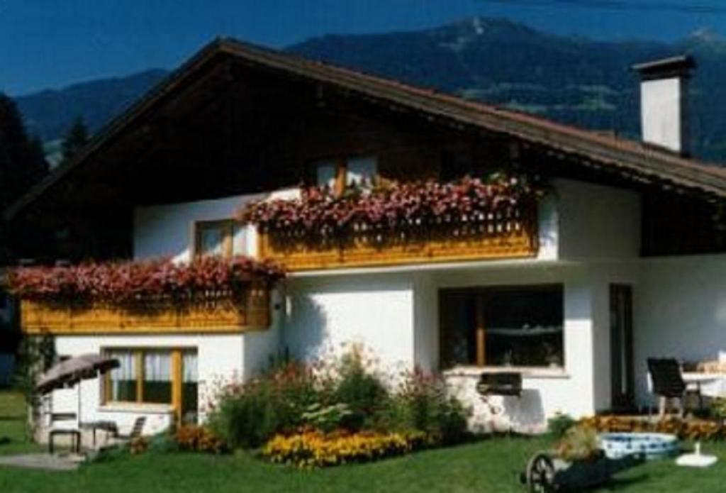 a house with a balcony with flowers on it at Haus Salzgeber Angelika in Schruns