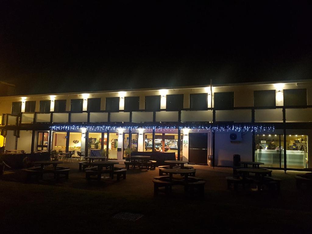 a building with tables and lights at night at The Shipwreck Loft in Shotley Gate