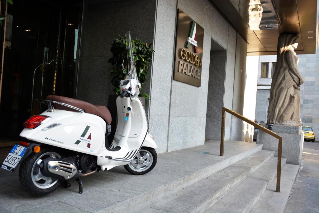 a motorcycle parked in front of a store at Allegroitalia Golden Palace in Turin