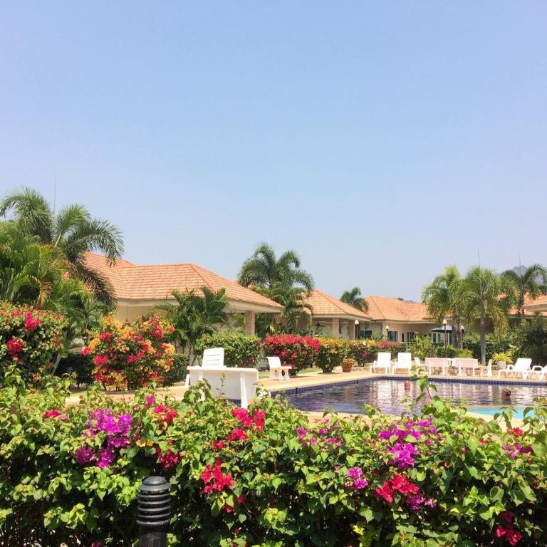 a resort with a swimming pool and some flowers at Hua Hin in Hua Hin
