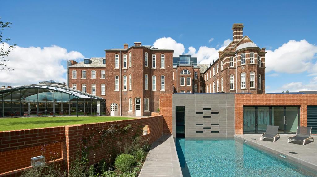 a building with a swimming pool in front of a building at Hotel du Vin Exeter in Exeter