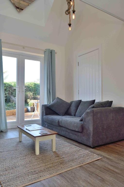a living room with a couch and a coffee table at Little Fernleigh in Perranporth