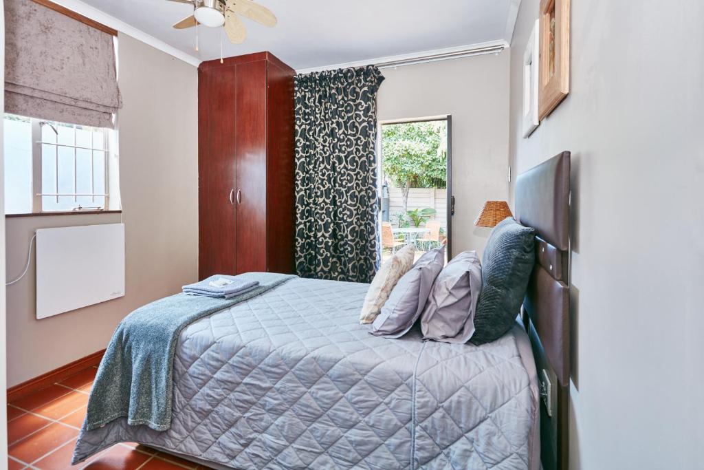 a bedroom with a bed and a window at 1202 on Cowgill in Pretoria