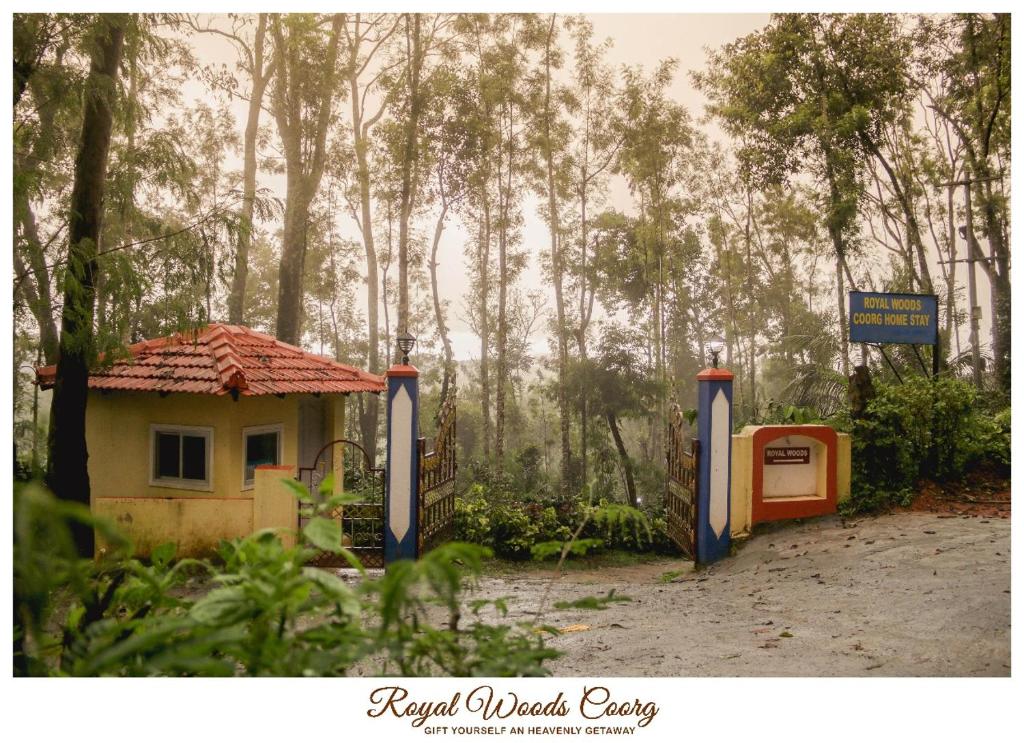 a small house and a gas station in a forest at Royal Woods Coorg in Madikeri