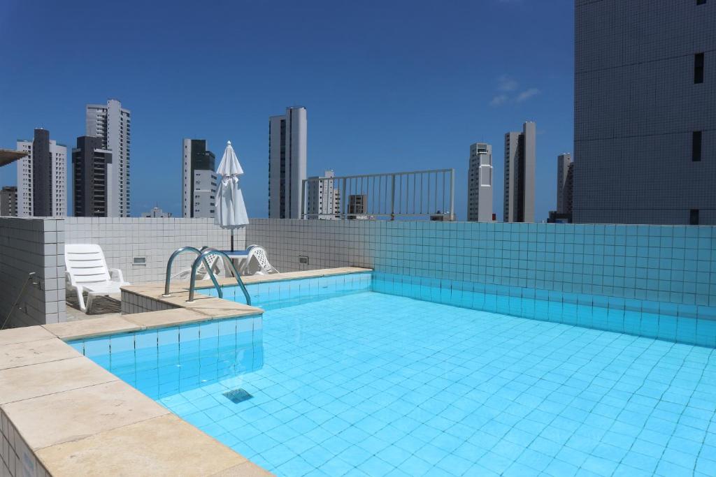 a swimming pool on the roof of a building at Apartamento Alice Tenório in Recife