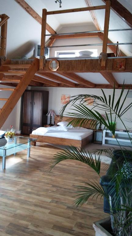 a room with a bed and a loft with a staircase at NEUSTADT Villa in Cristian