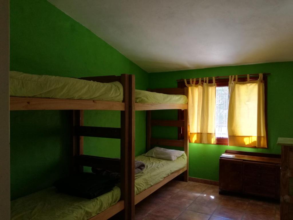 a bedroom with two bunk beds and a window at Espejo Escondido in Tanti