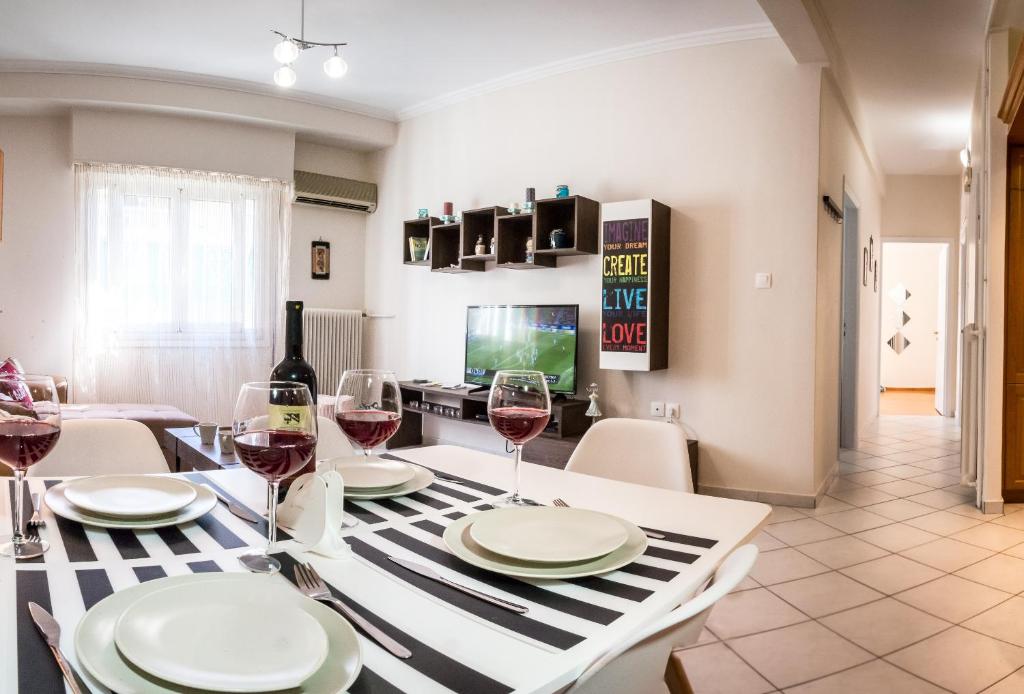 a dining room with a table with glasses of wine at Pisces - City Center Apartment in Athens