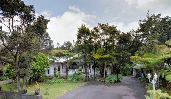 a house with a lot of trees and a driveway at Country Goose in Volcano
