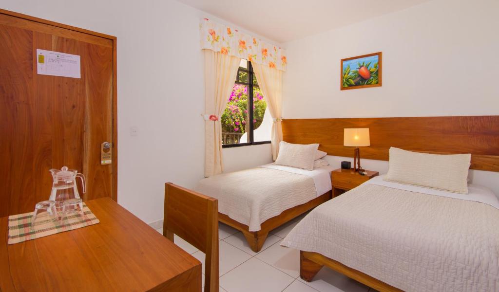Postel nebo postele na pokoji v ubytování Hotel Fiesta