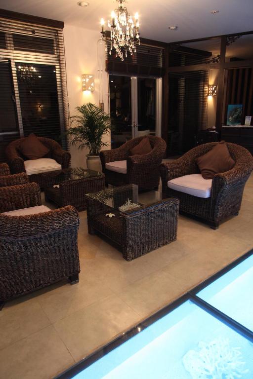 a living room with wicker chairs and couches at Kerama Terrace in Tokashiki