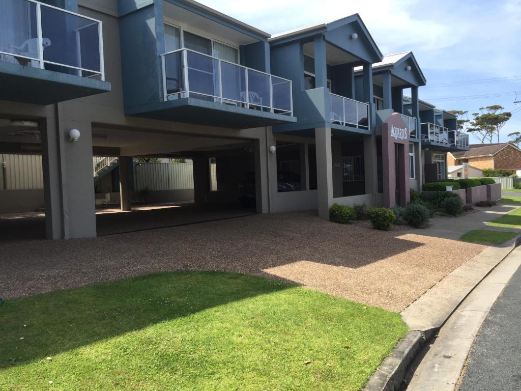 a large apartment building with balconies and a driveway at Aquarius Apartments Mollymook in Mollymook