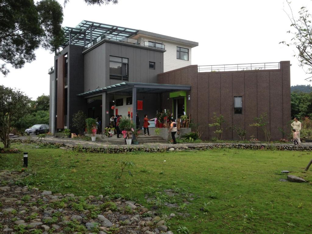 a building with people standing outside of it at Beetles Forest in Jiaoxi