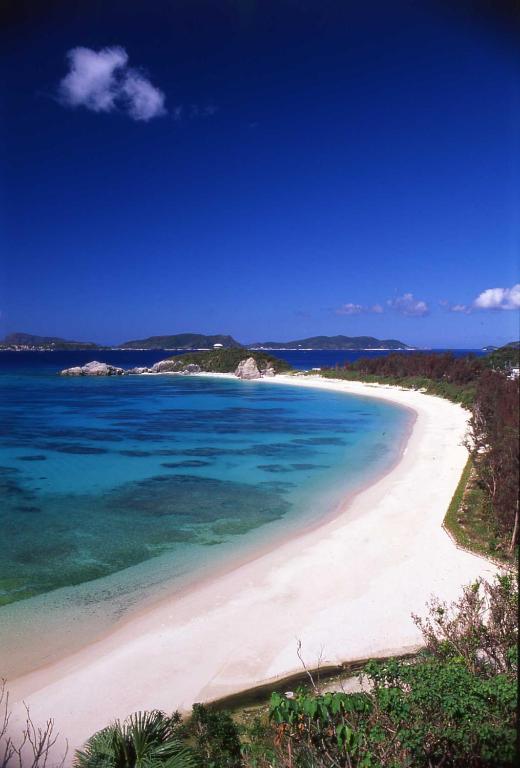 a view of a white beach with the ocean at Kerama Terrace in Tokashiki