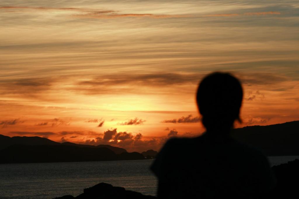 a person looking out at the sunset at Kerama Terrace in Tokashiki