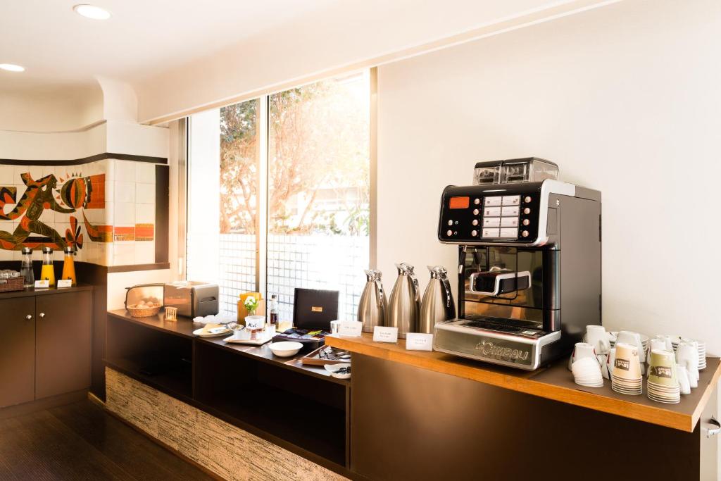 a kitchen with a counter with a coffee maker at Hôtel Hélios in Juan-les-Pins