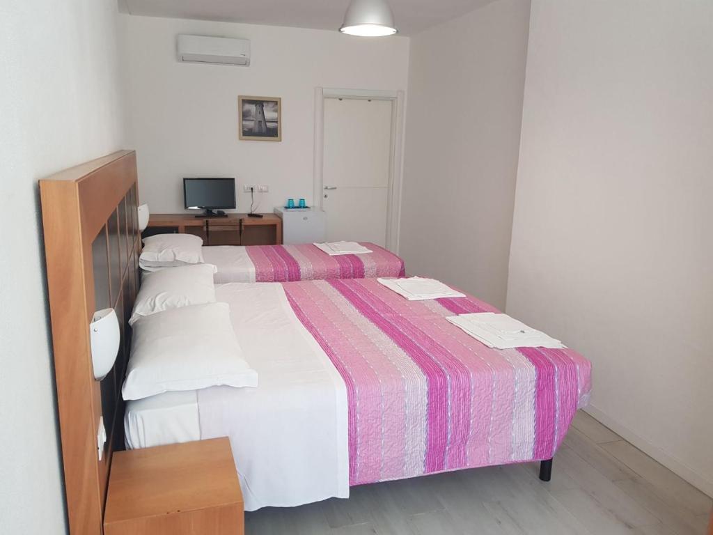 Postel nebo postele na pokoji v ubytování Duna camere con bagno