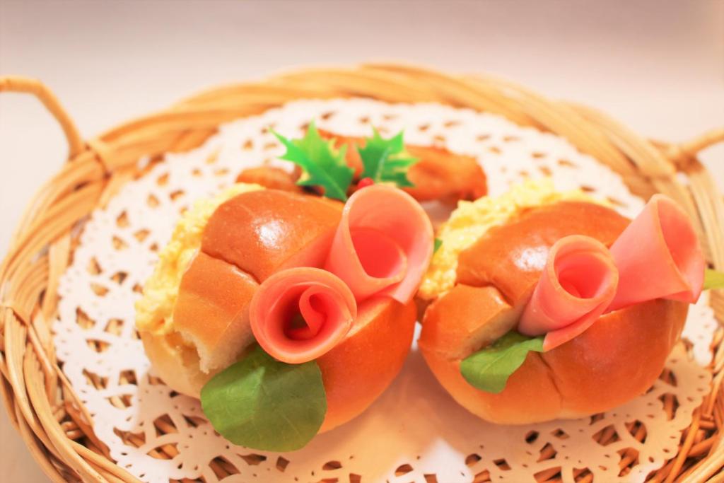 a basket of food with flowers on top of it at Pal Annex Yamaguchi (Love Hotel) in Iwakuni