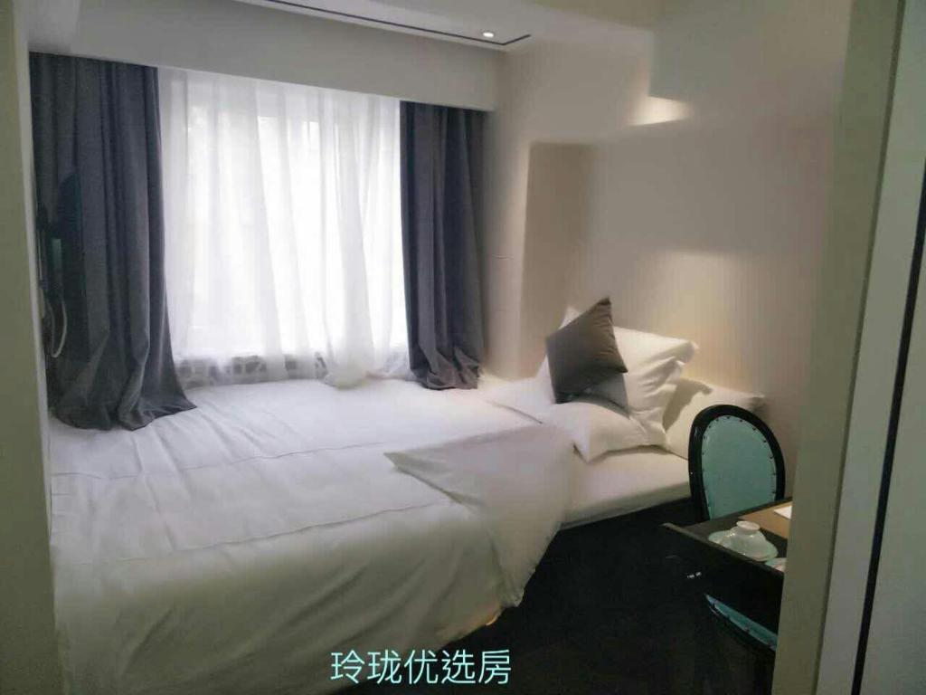 Postel nebo postele na pokoji v ubytování Xana Hotelle Beijing Tianqiao