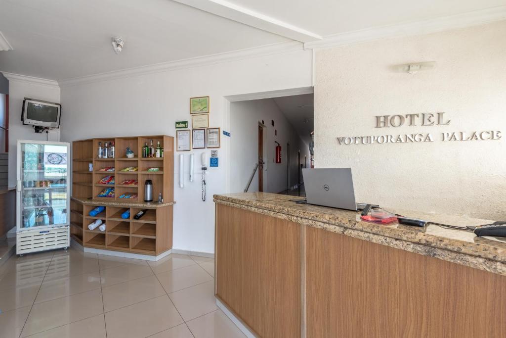 a hotel counter with a laptop on top of it at Hotel Votuporanga Palace in Votuporanga