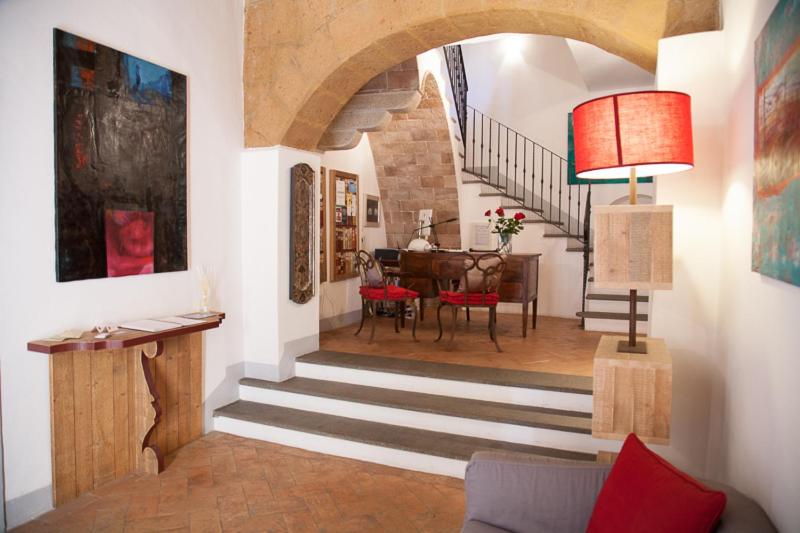 a living room with a staircase leading to a dining room at Sant'Angelo 42 in Orvieto