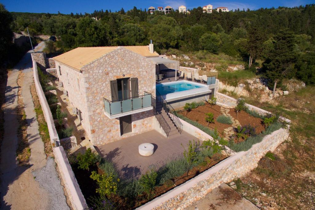 an aerial view of a stone house with a swimming pool at Euphoria Retreat in Mánganos