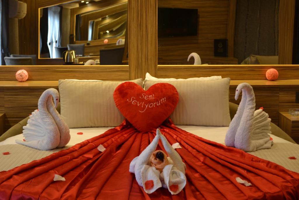 a bed with two swans and a heart on it at Gumus Palace Suites in Istanbul