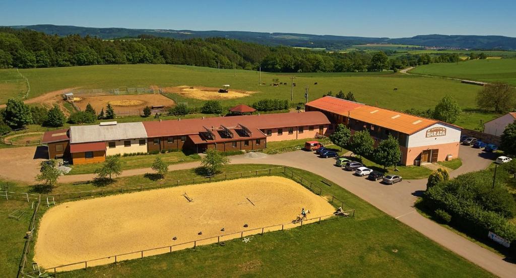 an overhead view of a farm with a building and a field at Resort Ohrada in Vísky