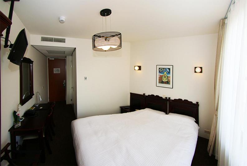 En eller flere senger på et rom på Hotel Keistad