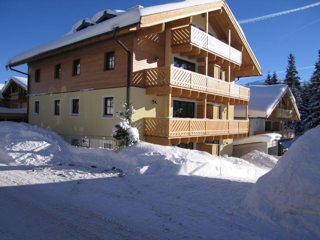 a building with a pile of snow in front of it at Fewo Simone in Königsleiten